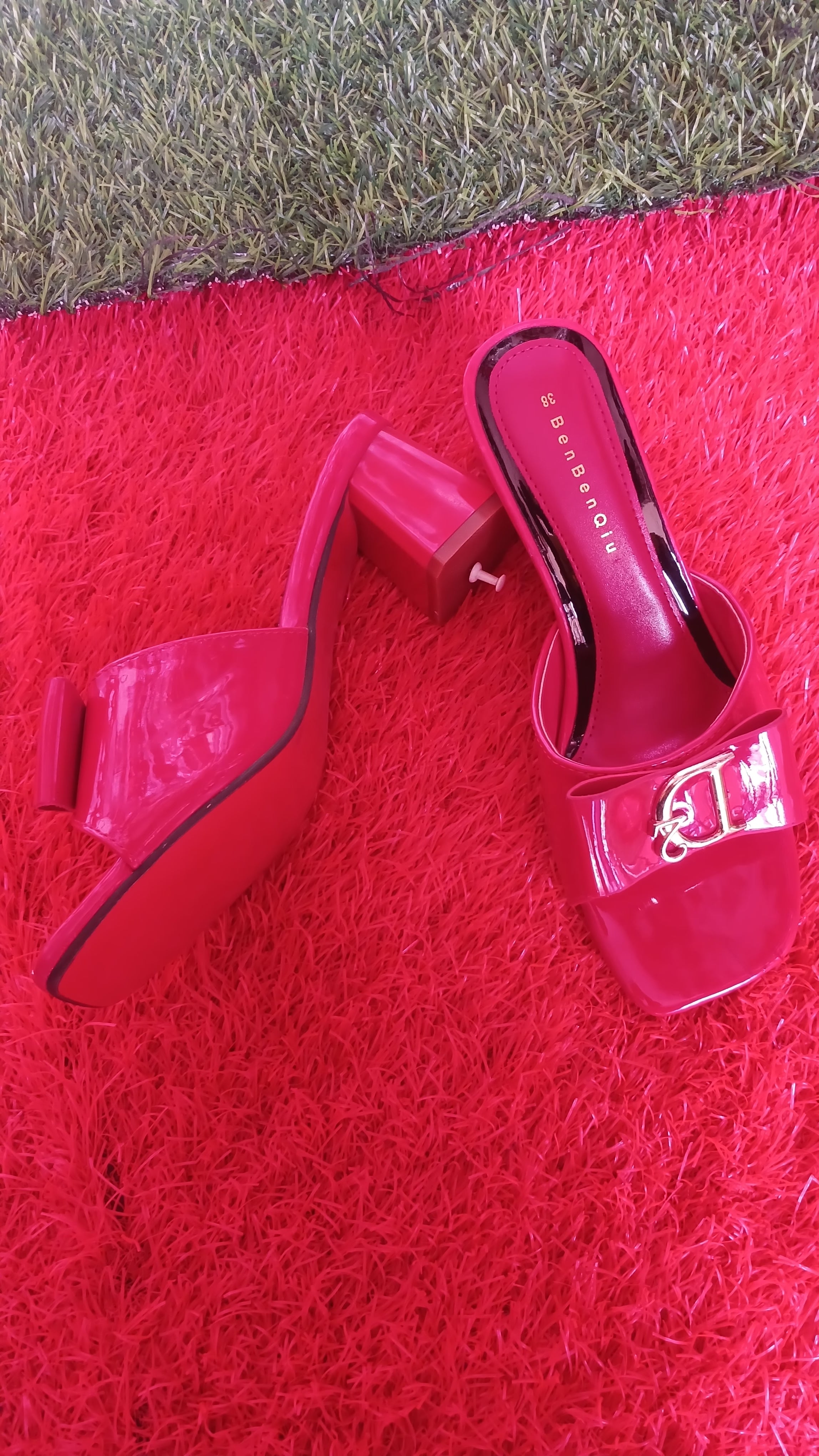 BenBenQiu pink slip-on heels prominent metallic letter emblem.