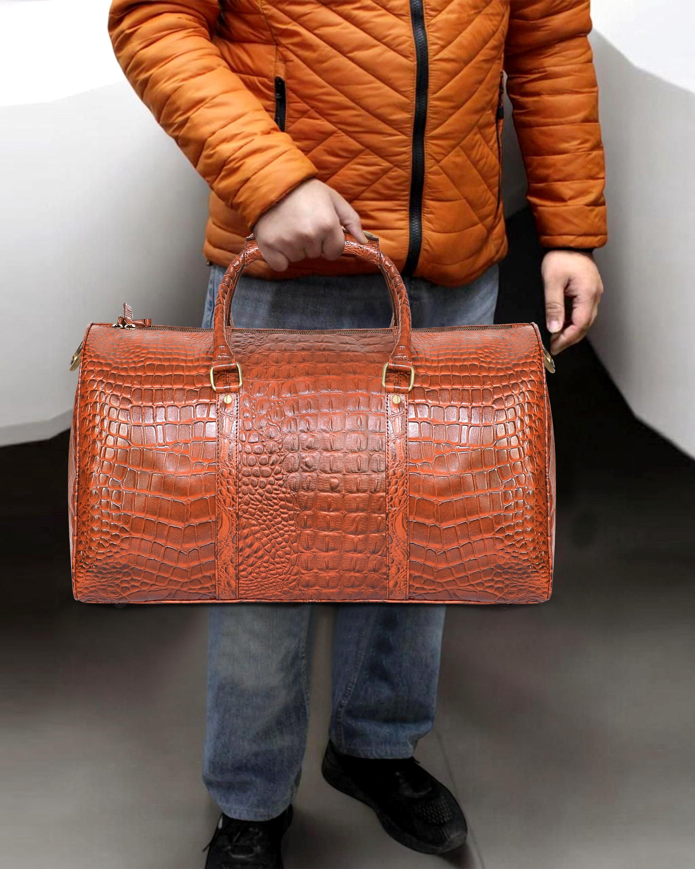 orange crocodile embossed duffle bag.