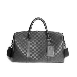 gray and black checkerboard pattern travel holdall bag featuring dark leather trim and a central logo plaque.