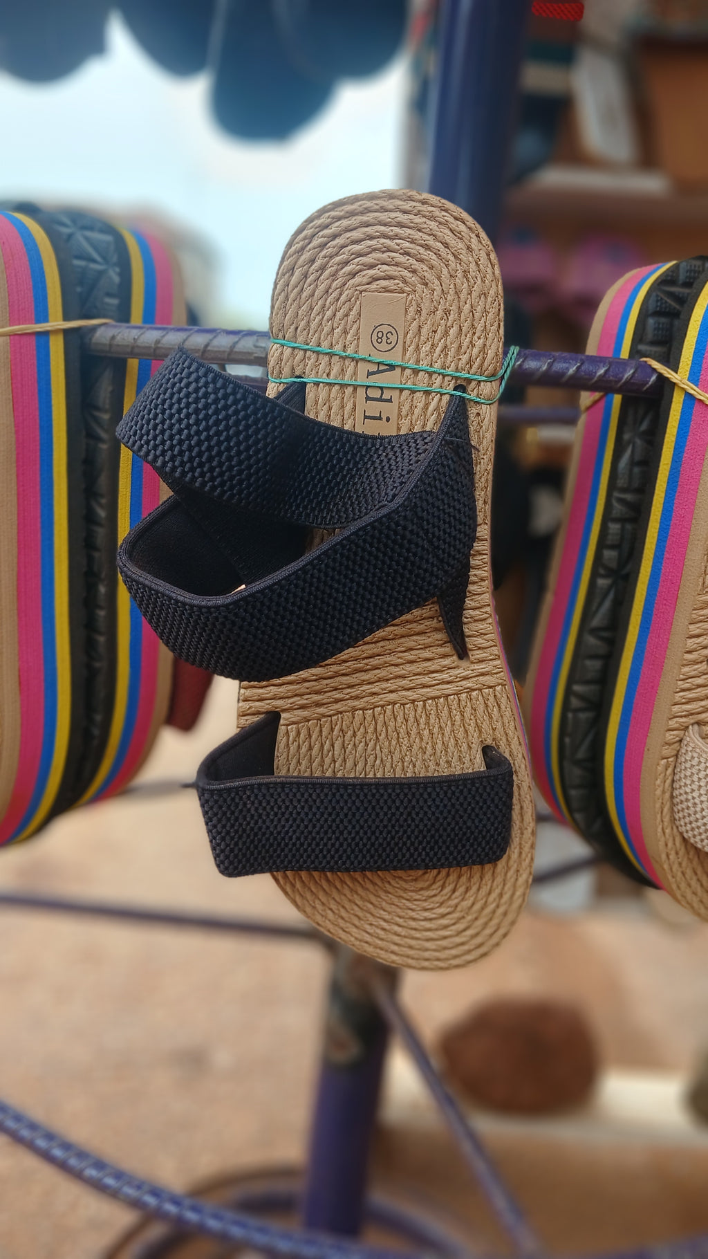 braided straw-style sole and elastic black straps sandals