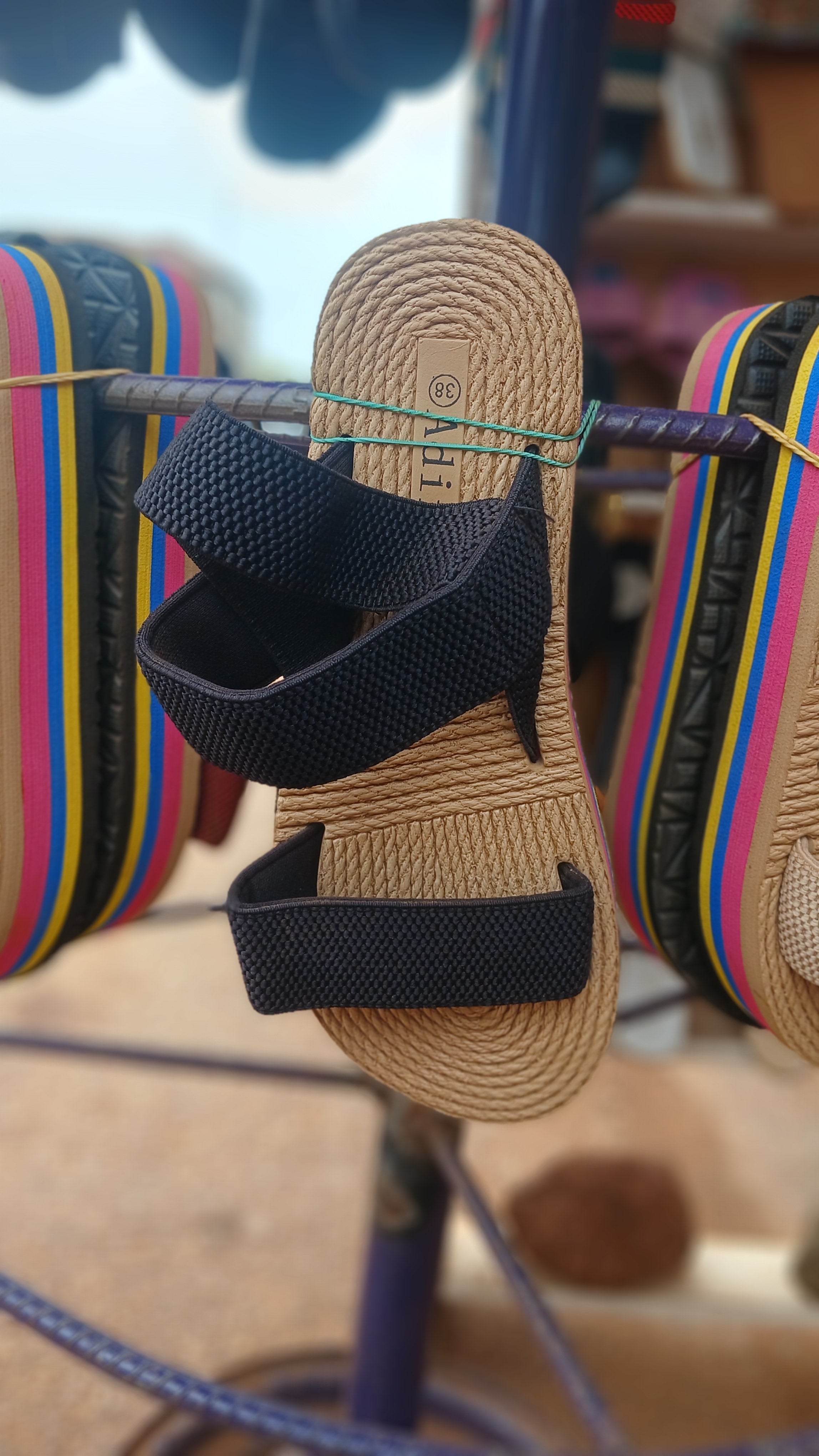 braided straw-style sole and elastic black straps sandals