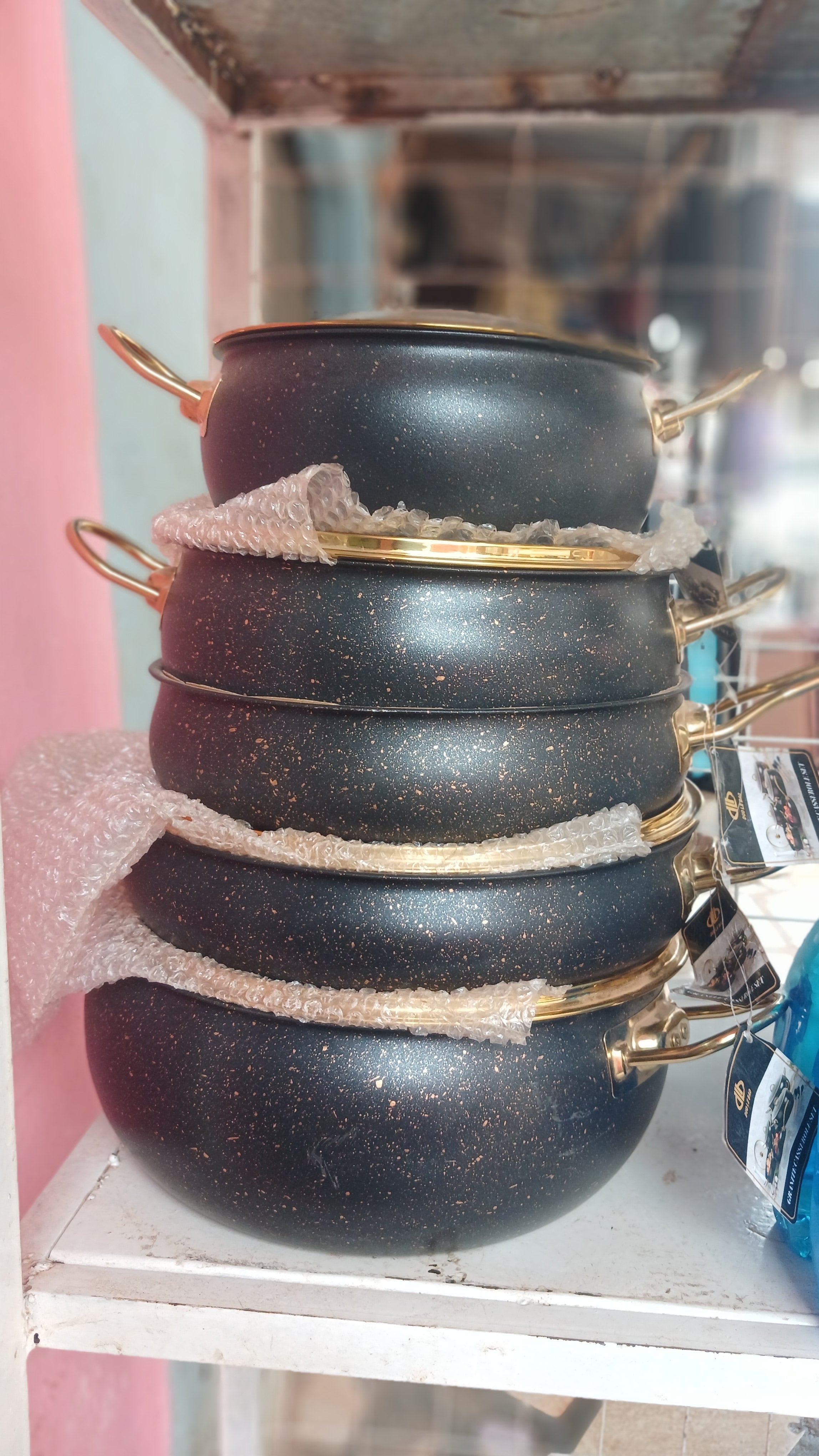 5 pieces granite-coated non-stick cookware featuring a distinctive black finish with gold accents and glass lids.