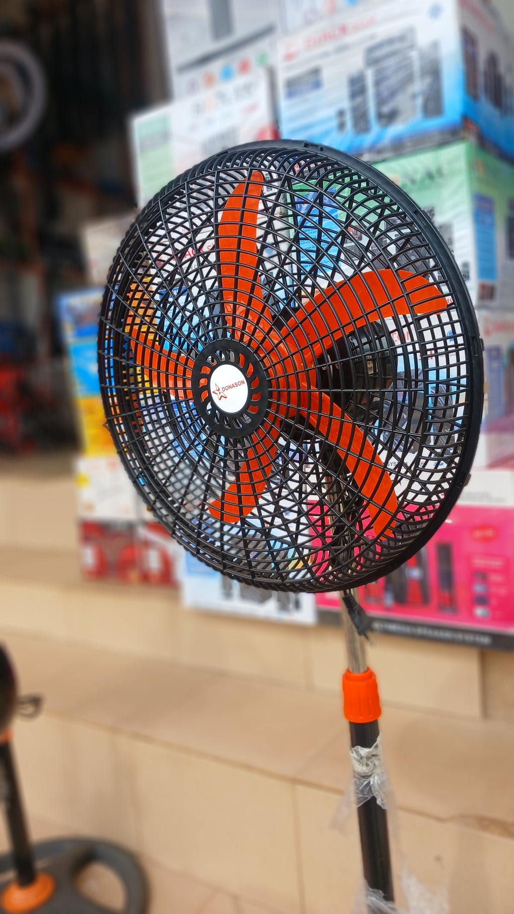 Donason electric floor fan, adjustable stand tilting head, and oscillation for directional airflow.