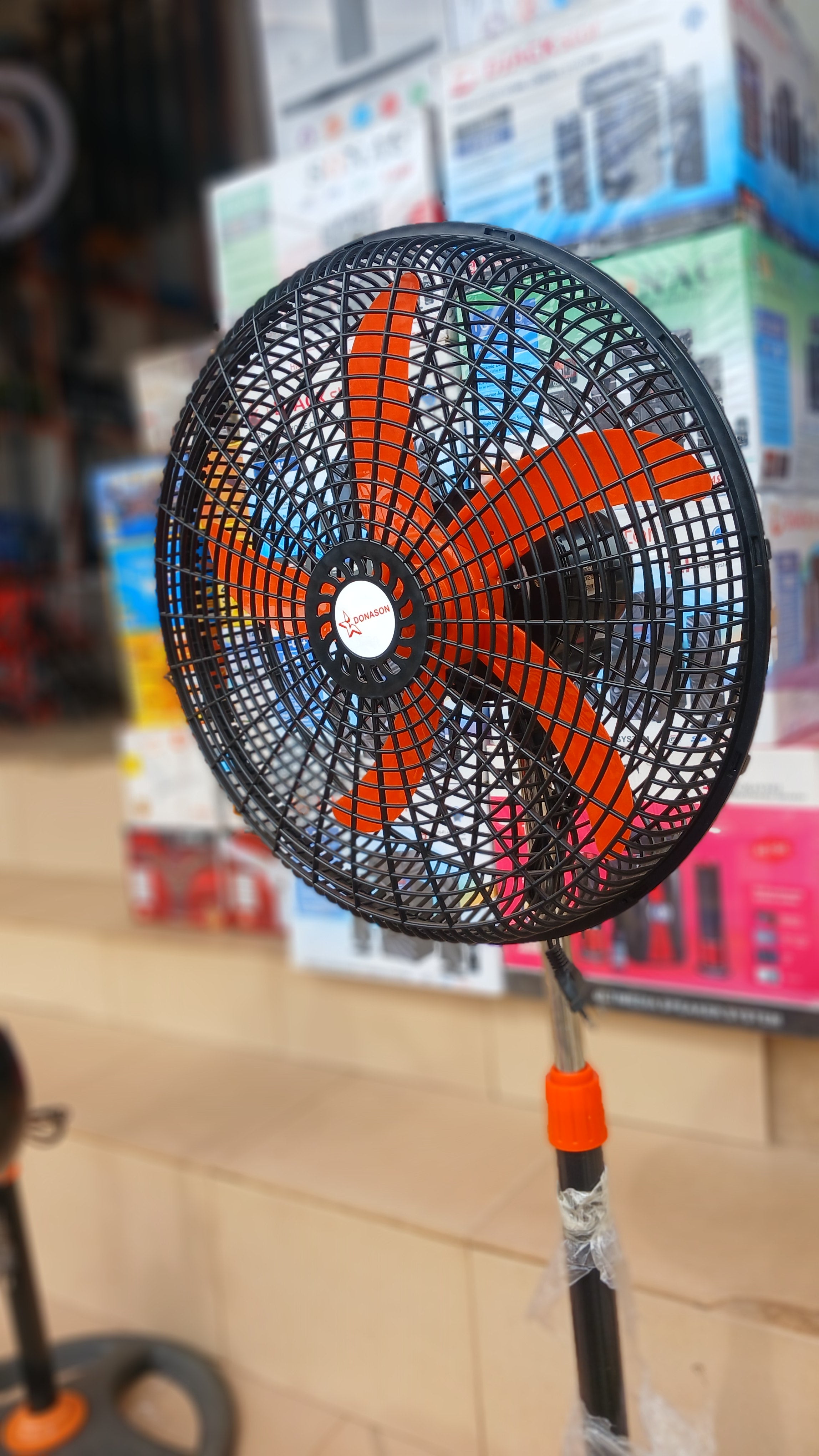 Donason electric floor fan, adjustable stand tilting head, and oscillation for directional airflow.