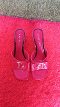 BenBenQiu pink slip-on heels prominent metallic letter emblem.