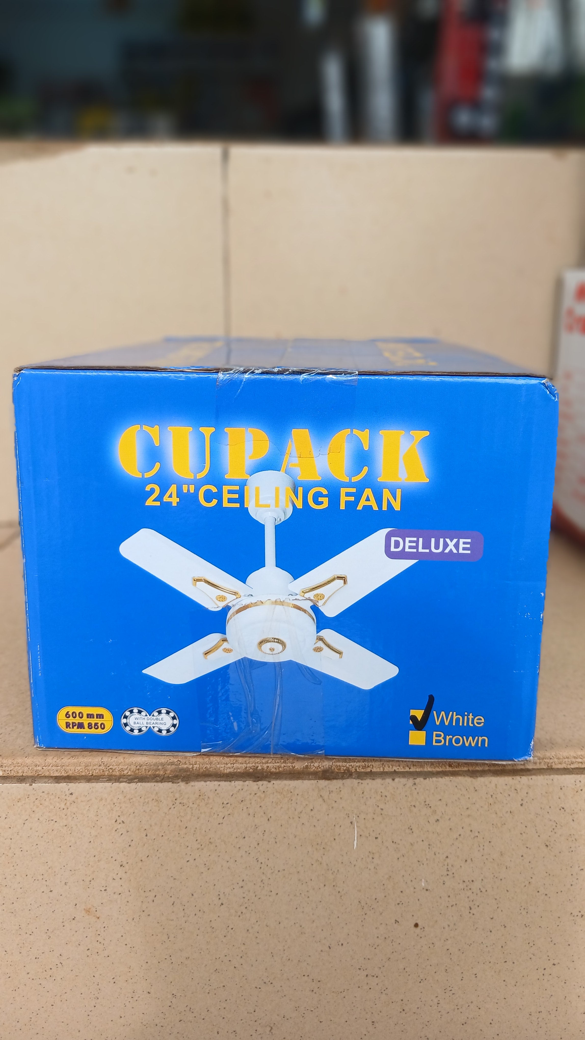 Cupack 24" Deluxe Ceiling Fan is a compact 4-blade fan designed for smaller spaces, featuring a white finish with gold accents and a sweep size of 600 mm.