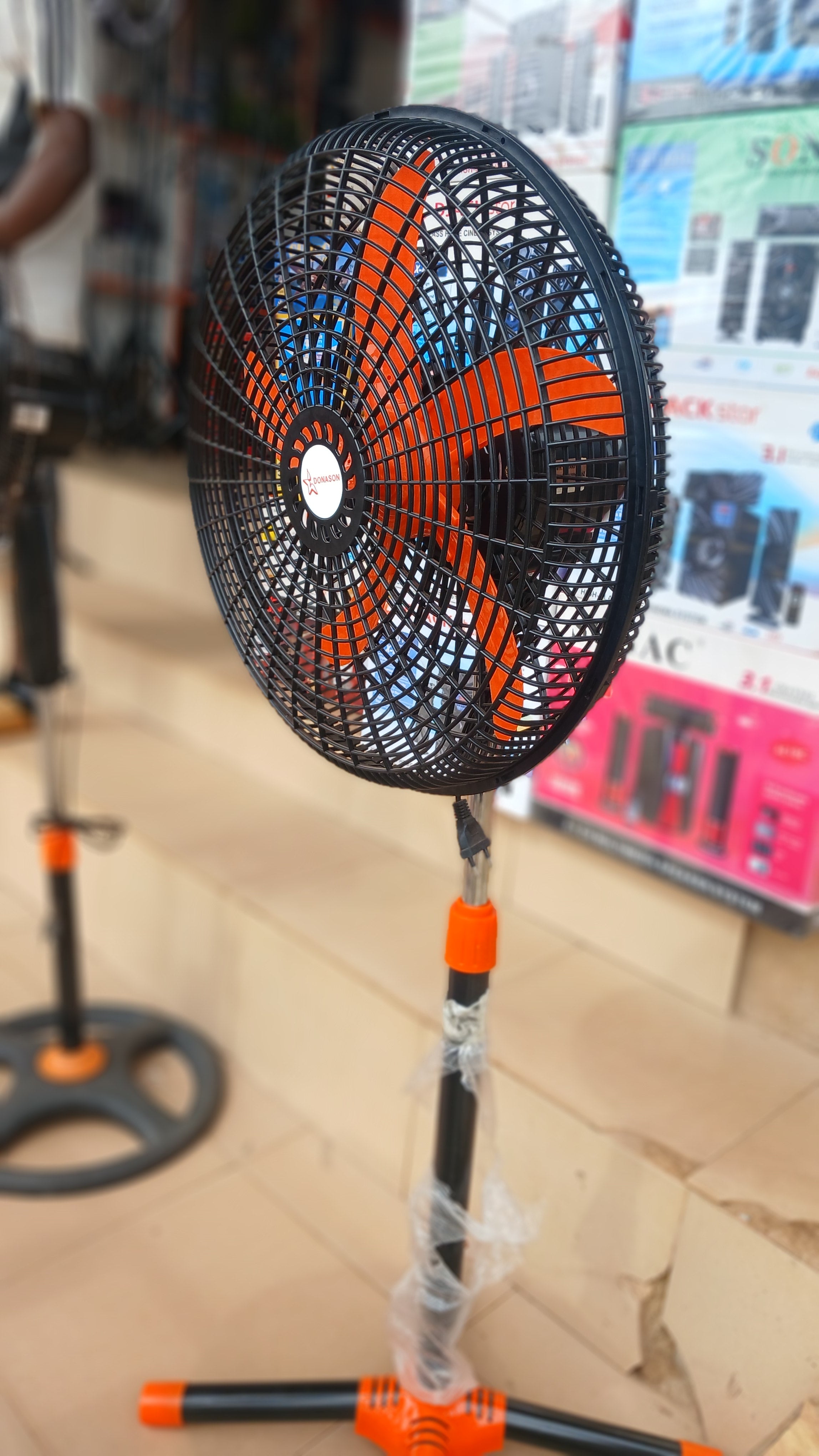 Donason electric floor fan, adjustable stand tilting head, and oscillation for directional airflow.