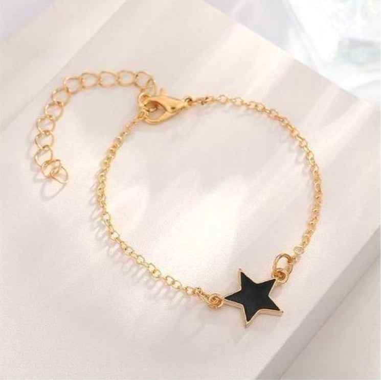 SXCHEN 4 Piece Women's Jewelry Set, which includes a necklace, bracelet, earrings, and a ring in a black and gold star design.